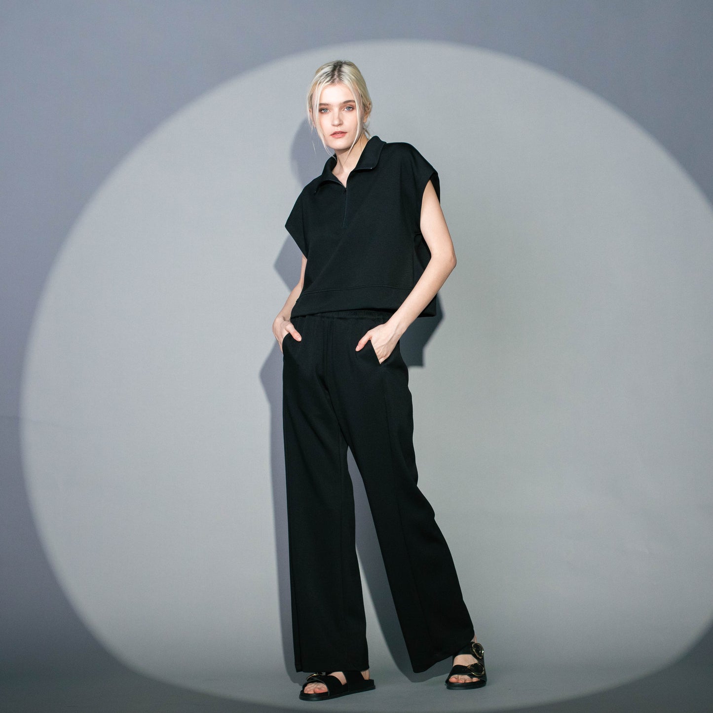 black zip neck crop top paired with elastic garter waistband wide leg pants with side pockets